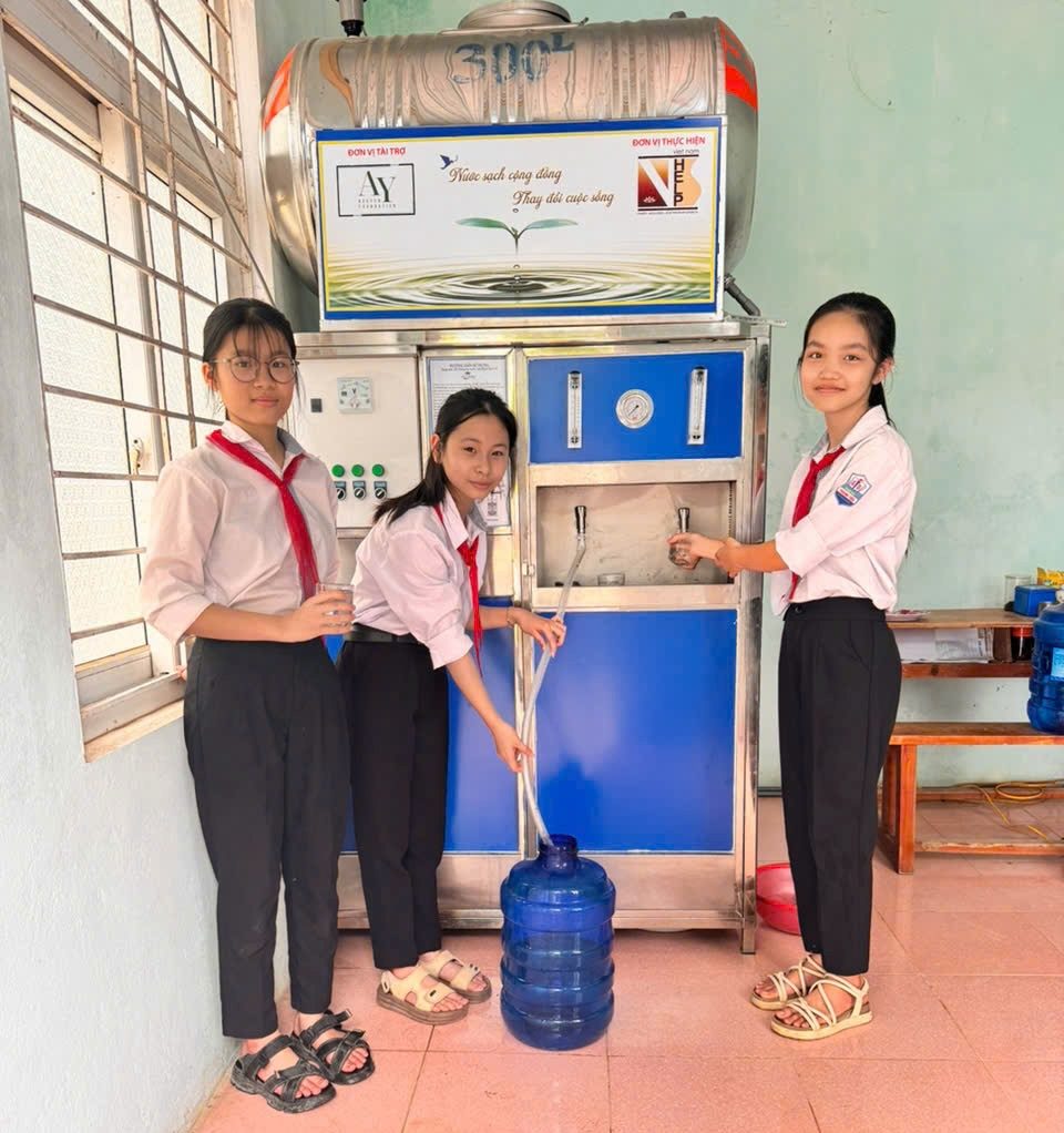 Students drawing clean water from the new filtration system