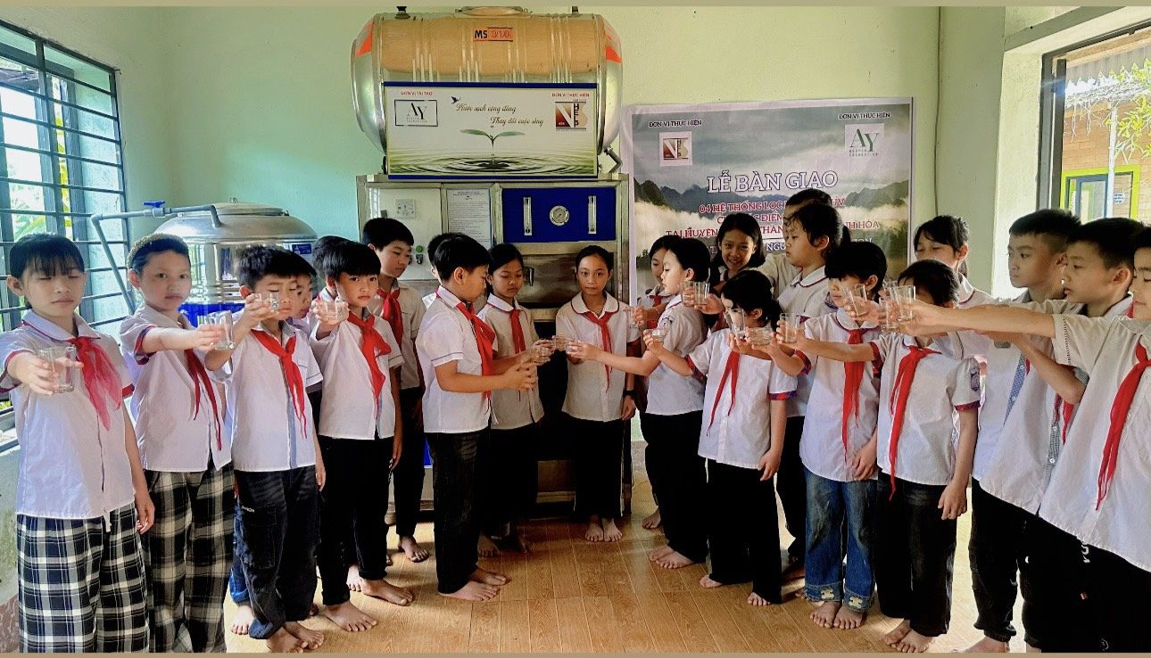Students toasting with glasses of clean water